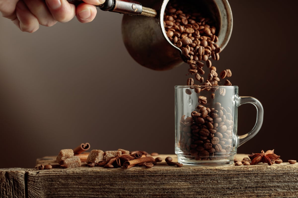 Coffee beans with anise and cinnamon on rustic wood table
